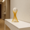 Escultura Dourada com Esfera de Vidro